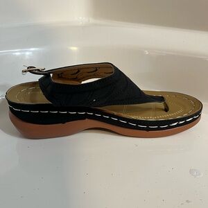 Black leather sandals with white stitching